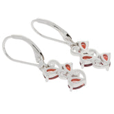 Pear red garnet sterling silver earrings with elegant design and sparkling gemstone accents.